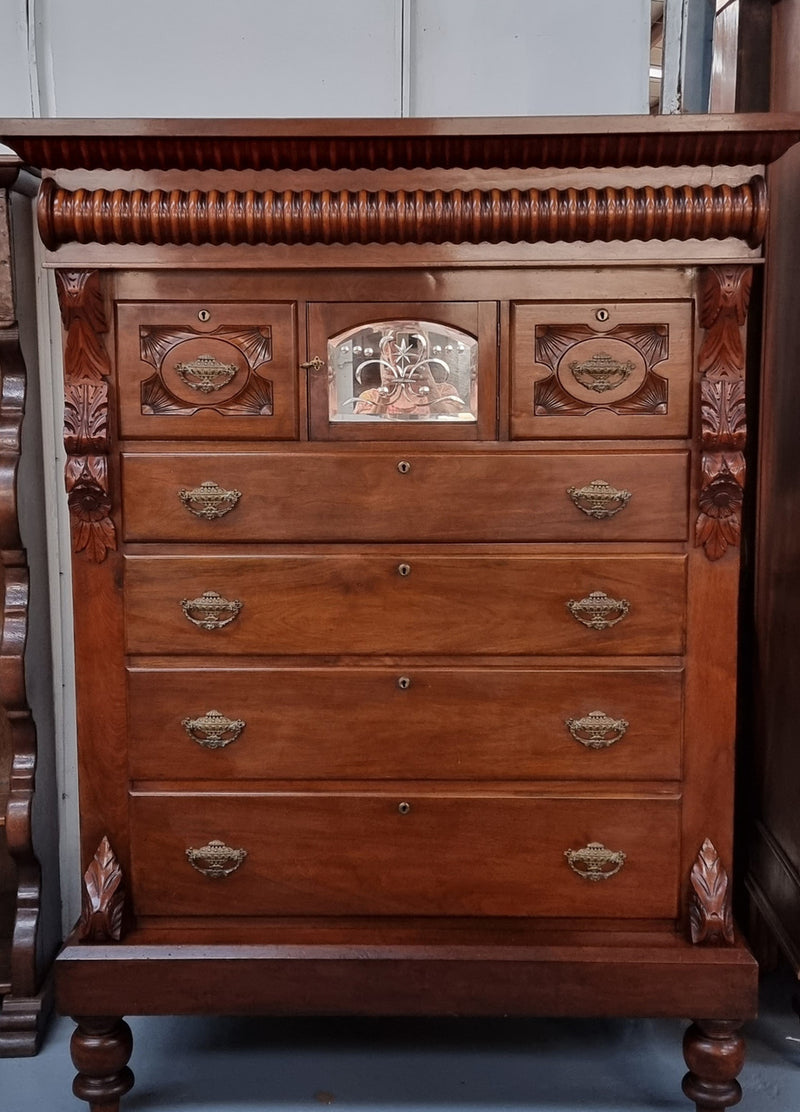 A 19th Century Scottish Mahogany tall boy/ chest of six drawers with small cabinet section at the top. Beautiful carvings and easily comes apart into three sections making transport for moving into place easy. In good original detailed condition.