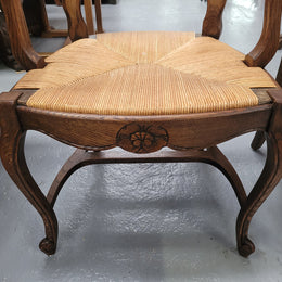 Pair of Louis XV Style Oak framed rush seated carver chairs. They have been sourced from France and in good original detailed condition.