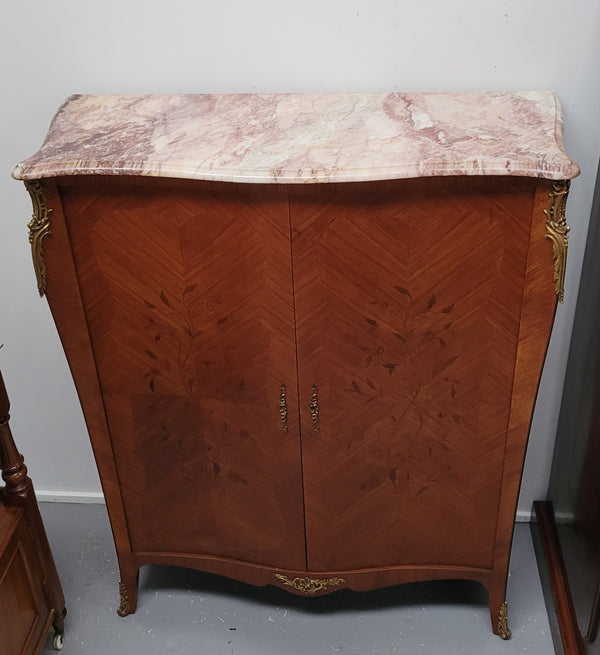 French Louis 15th style Kingwood marquetry inlaid two door cupboard with a beautiful marble top. It has three adjustable shelves and decorative ormolu trim. It has been sourced from France and is in good original detailed condition.