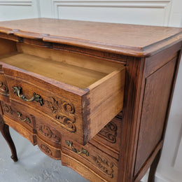 Vintage French dark Oak Louis XV style chest of three drawers. It has beautiful cabriole legs, elegant brass handles and decorative carving throughout. It is in good original detailed condition and has been sourced from France.
