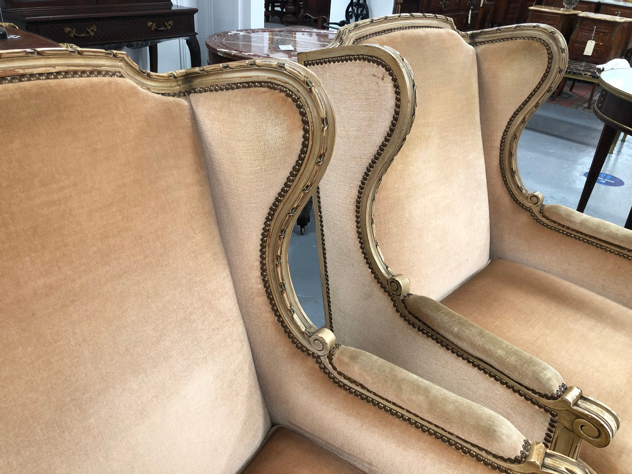 Pair of Vintage French original painted bergere wingback armchairs. The fabric is in very good original condition, please view photos as they help form part of the description. Please note the matching foot stool is being sold separately.