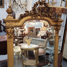 French Louis XVI style Napoleon III (1870’s) gilt mantle mirror. Beautifully carved and decorated with original bevelled mirror showing signs of age. It is in good original detailed condition and has been sourced from France.