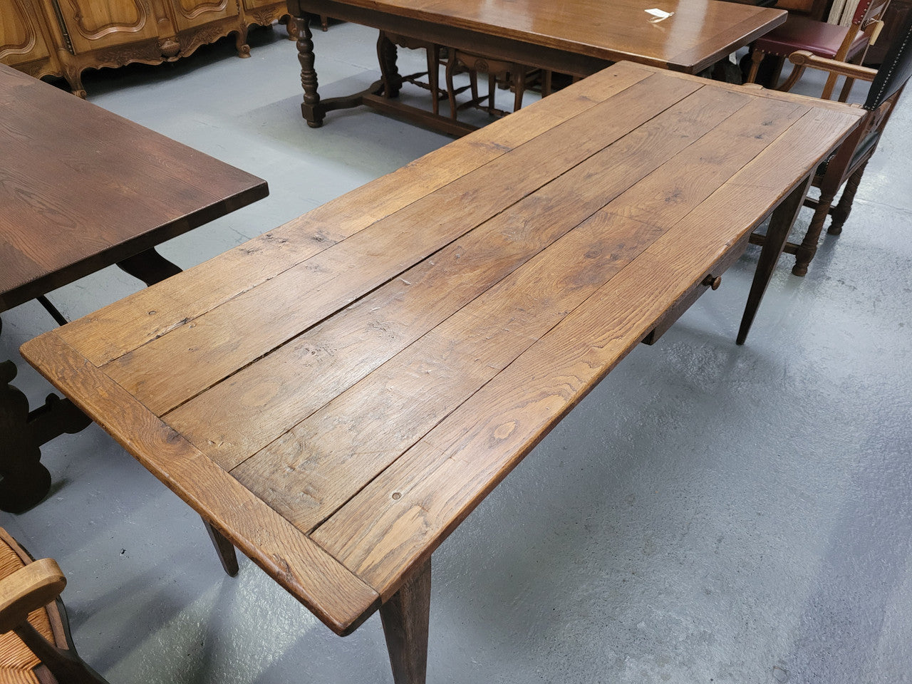Provincial 19th Century French Oak rustic farmhouse table with tapered leg and single drawer. It has been sourced from France and is in good original detailed condition. 