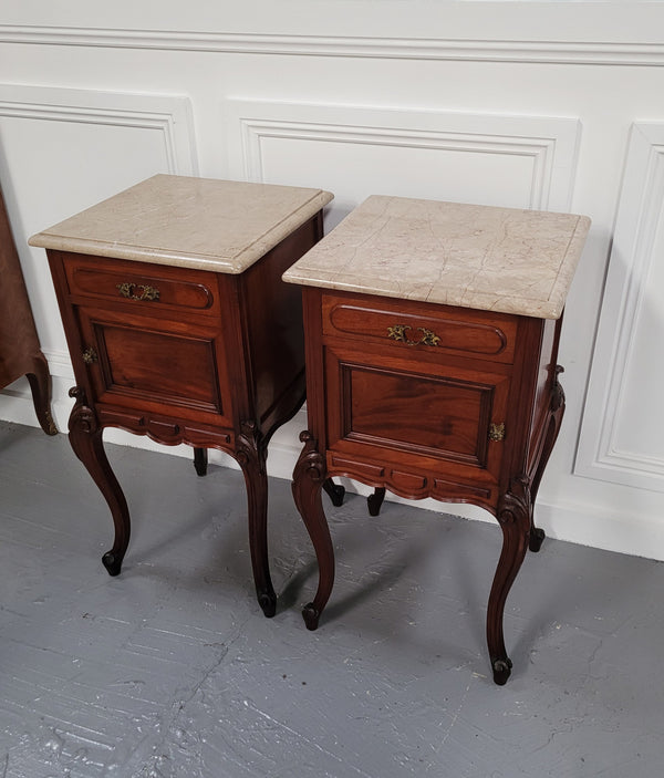 Pair of French Antiloopque Louis XV style Walnut and marble top bedsides. They have lovely carvings along with a drawer and cupboard space. They are in good original detailed condition and have been sourced from France