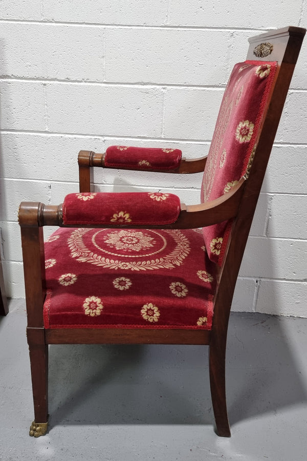 Pair of large French Empire style armchairs with ormolu mounts and impressive red upholstery. They are in good original condition.