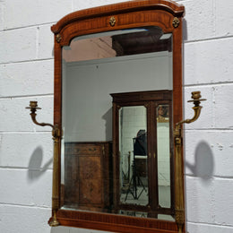 Decorative late 19th Century mahogany French wall mirror with brass swivel candle holders and brass detail. In good original detailed condition.