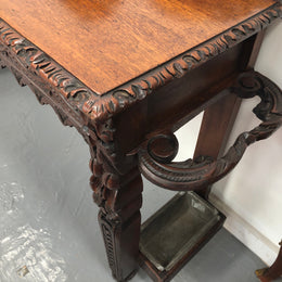 Superb 19th Century Gothic style hall/console table. It has umbrella and walking stick holders on both sides. In good original detailed condition.