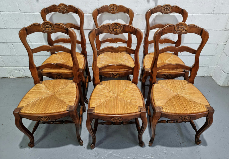 Set of six French Cherrywood rush seat dining chairs. In good restored condition.