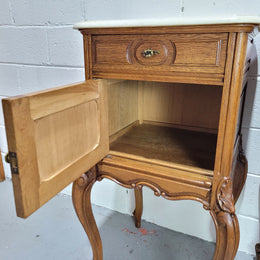 Pair of Louis XV style bedside cabinets with beautiful marble tops and one drawer and single cupboard for all your storage needs. In good original detailed condition.