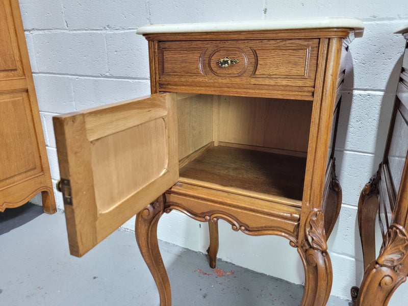 Pair of Louis XV style bedside cabinets with beautiful marble tops and one drawer and single cupboard for all your storage needs. In good original detailed condition.