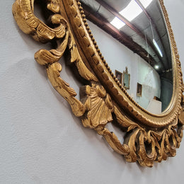 Vintage large round ornate convex mirror. Lovely gilt decoration around and is in good original condition.