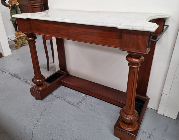 Classic Victorian mahogany console table with white marble top, one drawer and accommodation for sticks/umbrellas. In good original detailed condition.