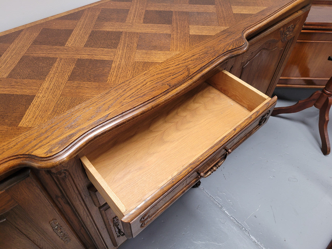 French Oak Louis XV style three door, two drawer, parquetry top sideboard. It has been sourced from France and is in good restored condition.