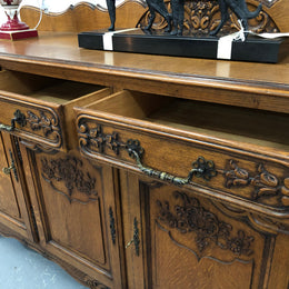 French Louis XV style Oak sideboard with beautiful carvings. Plenty Of storage space with four cupboards and two drawers. In very good original detailed condition.