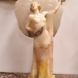 Monumental Art Deco alabaster and marble figural lamp modelled as a seductively dressed semi naked woman. In subtlety coloured diaphanous robes with a large clam shell light backdrop. Italian circa 1920's signed to base. This is a world class example of a true Art Deco sculpture lamp. It is in good original detailed condition, please view photos as they help form part of the description.