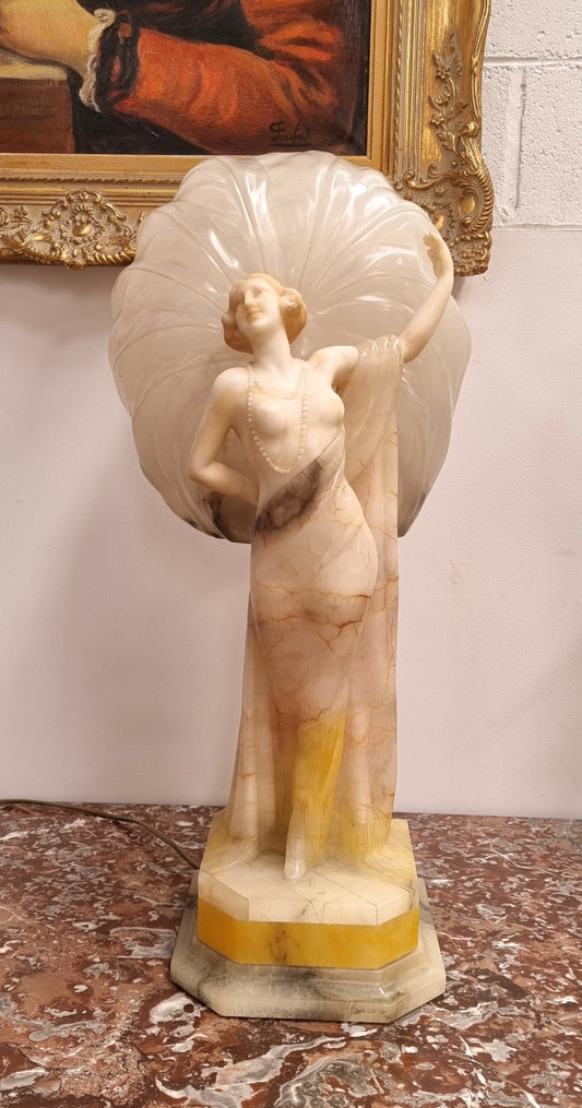 Monumental Art Deco alabaster and marble figural lamp modelled as a seductively dressed semi naked woman. In subtlety coloured diaphanous robes with a large clam shell light backdrop. Italian circa 1920's signed to base. This is a world class example of a true Art Deco sculpture lamp. It is in good original detailed condition, please view photos as they help form part of the description.
