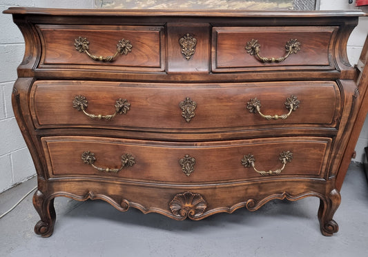 Impressive French Louis XV style Cherrywood four drawer commode, with a wooden top, two large drawers and two smaller drawers. Features attractive handles and a carved skirt and feet. In good original detailed condition.