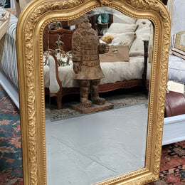 Beautiful French Napoleon III Louis XV style gilt framed bevelled mirror with an ornate crest on top. It has been sourced from France and is in good original detailed condition with the mirror showing signs of age.