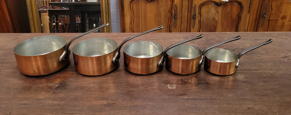 Set of five copper sauce pans with foundry stamp. They have been sourced from France and are in good original detailed condition.