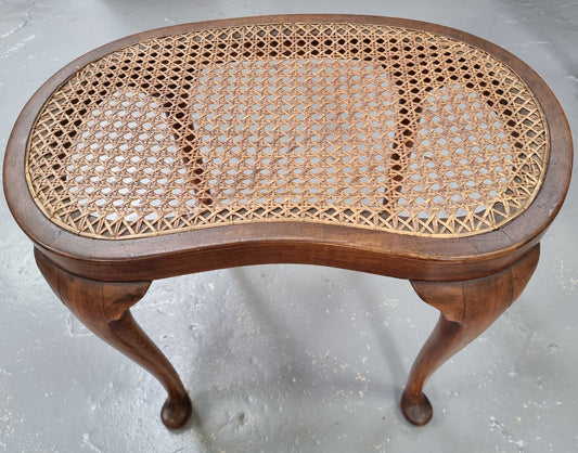 Hard to find English stool with cane top. Kidney shaped with beautiful cabriole legs and is in good original condition.