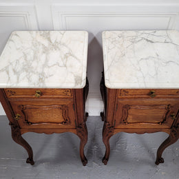 Pair of French Antique Louis XV style Oak marble top night stands. They have beautiful carved cabriole legs and beautiful white marble along with a drawer and cupboard for storage space. They have been sourced from France and are in good original detailed condition.