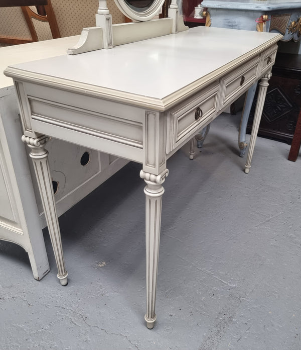 French Louis XVI style painted dresser / console with beveled oval mirror and three drawers. Sourced from France and in good original detailed condition.