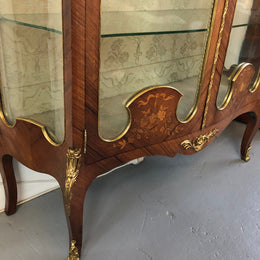 19th Century ornate French Walnut marquetry inlay display cabinet. Has beautiful ornate ormolu mounts and its original glass. In good original detailed condition.