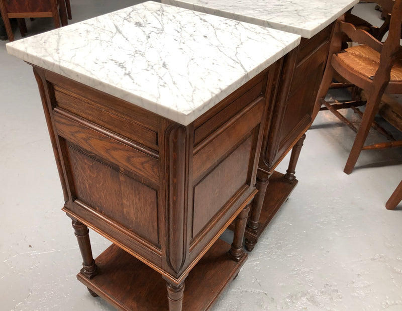 A french oak pair of carved bedside cabinets, with lovely detail and nice coloured marble tops and plenty of storage space. In good condition.