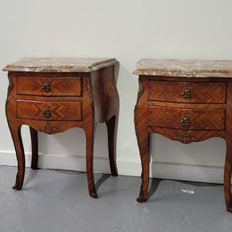 Pair of Louis XV commode style two drawer bedsides with beautiful marble tops and decorative mounts. They are a rare size and are in good, detailed condition.