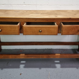 Late 19th Century Cherrywood console table with three drawers. In good used, detailed rustic condition.