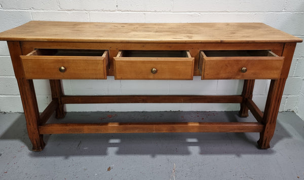 Late 19th Century Cherrywood console table with three drawers. In good used, detailed rustic condition.