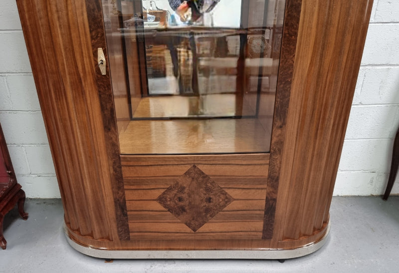 Stunning French Art Deco figured Walnut with Portoro marble top cocktail cabinet. Features chrome trim on base and glass display in door. It is in fully restored condition.
