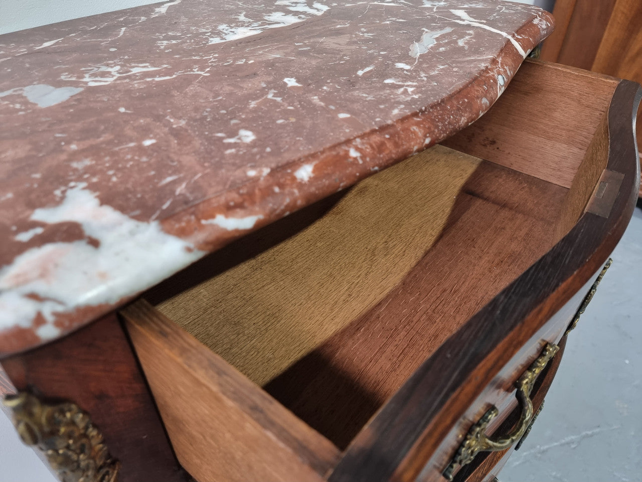 A stunning French petite two drawer inlaid Rosewood commode. In good original detailed condition.