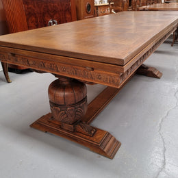 French Oak Renaissance style extension table with a stretcher base and heavily carved bulbous. When the table fully extends it measures 300 cm and can be used with both sides out or with only the one leaf out either side. It is in good original detailed condition.