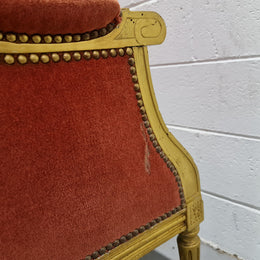 Antique Louis XVI style gilt upholstered bergere wingback chair. The fabric is in good used condition and the chair is very comfortable to sit in.