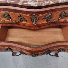 Antique French Louis XV style compact three drawer marble top commode with marquetry inlay and ormolu mounts. Sourced from France and in good original detailed condition.