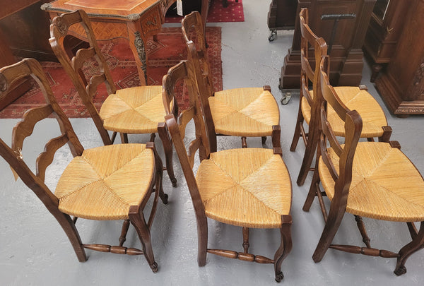 Set of six Louis XV style French Oak rush seat dining chairs. They are in good original detailed condition.