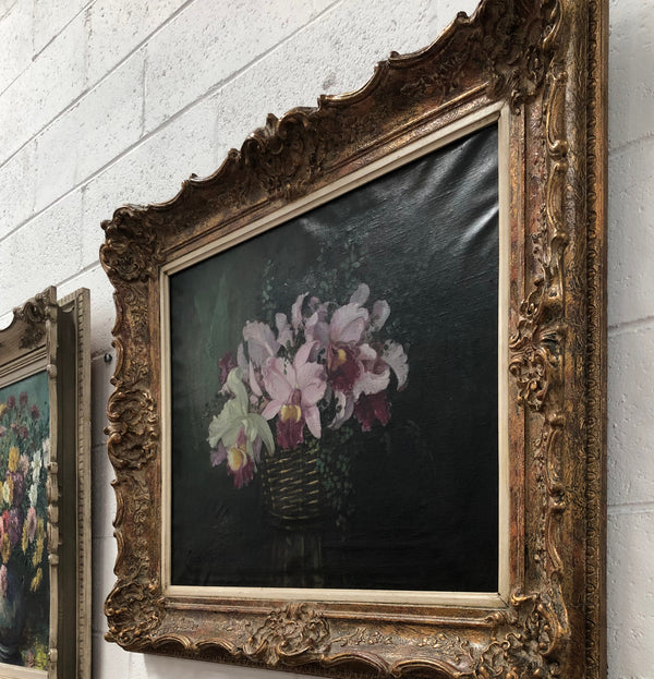 Signed French oil on canvas painting of "Orchids In Basket" In a beautiful ornate gilt frame. In good original detailed condition.