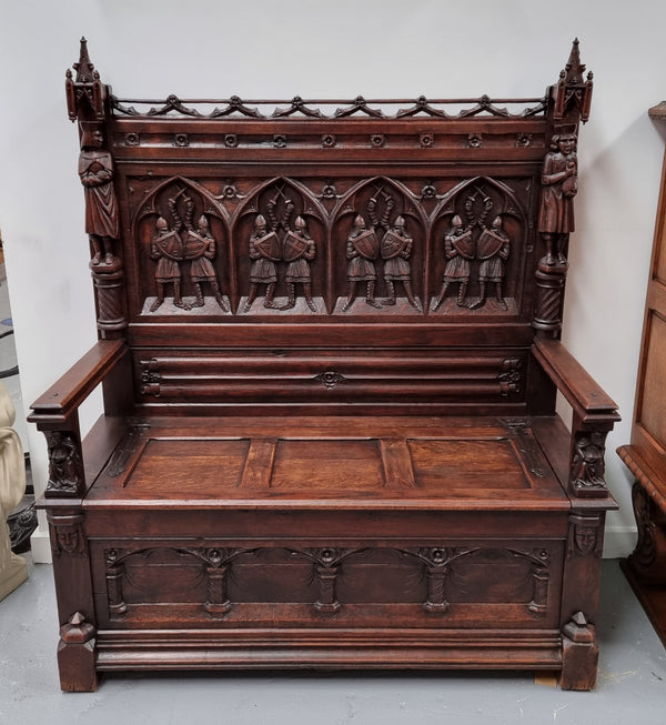 Early 19th Century French Oak Gothic style hall seat with a lift up seat. It has amazing detailed carvings and is in good original detailed condition.