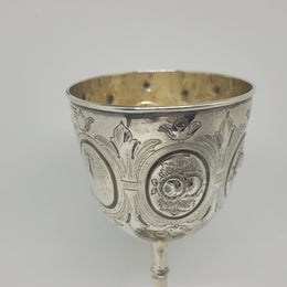 Unique Sterling Silver Christening Goblet With Repousse Motifs. Sheffield 1891. In very good original condition. Initials CJOB on one panel.