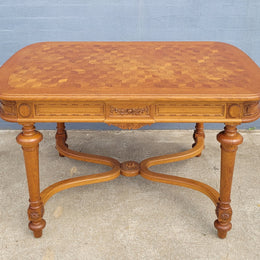 Beautiful carved French Oak dining table with a parquetry top and six matching upholstered chairs. All in good original detailed condition.