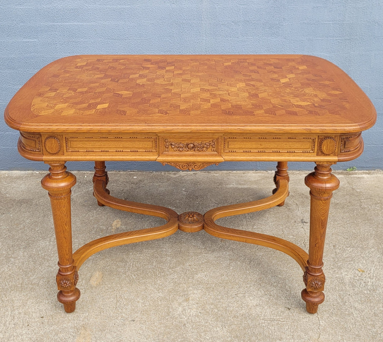 Beautiful carved French Oak dining table with a parquetry top and six matching upholstered chairs. All in good original detailed condition.