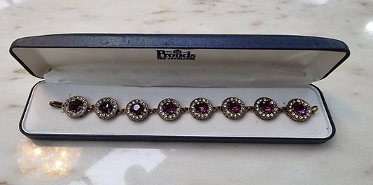 Beautiful Vintage bracelet with purple coloured jewels and lovely gold coloured decorative backing. It is in good original condition.