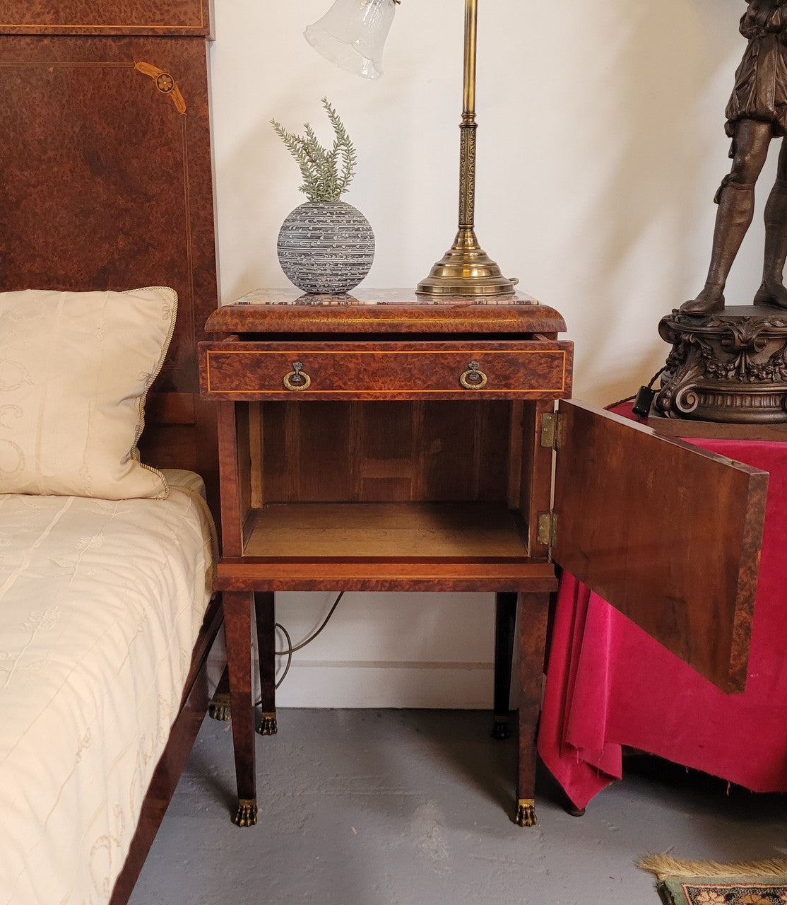 French Art Deco bedroom suite consisting of queen size bed in Amboyna wood and featuring pretty inlay. It comes with a matching pair of bedsides. It is a very stylish and high quality suite. It has been sourced from France and is in good original detailed condition.