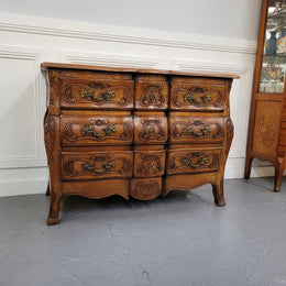 French Antique Louis XIV style Oak wooden top commode. It has a stunning serpentine bombe shape front along with amazing handles and carvings. It comes with three beautiful keys as pictured and comes with working locks. It has been sourced from France and in good original detailed condition.