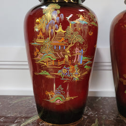 Matched  pair of very large Crown Devon hand painted Ruby lustre vases with Lids. They are in good original condition with no chips or cracks.