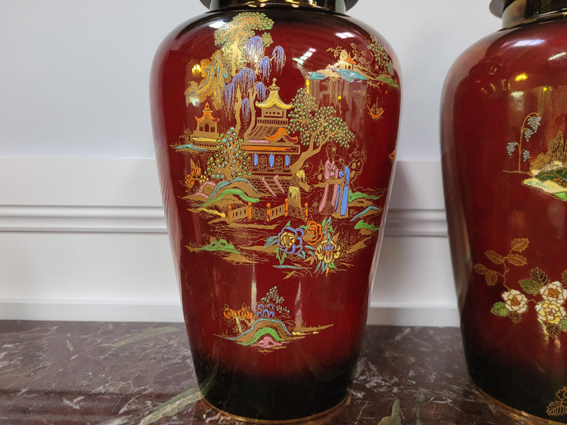 Matched  pair of very large Crown Devon hand painted Ruby lustre vases with Lids. They are in good original condition with no chips or cracks.