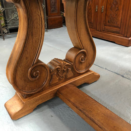 French oak fixed farmhouse table with a charming harp-shaped base. In good original condition and can seat 6-8 people. Circa 1930.