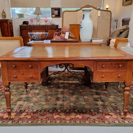 Australian Cedar full partners desk with attractive tooled leather top, four drawers either side and on caster wheels.  In good original detailed condition.