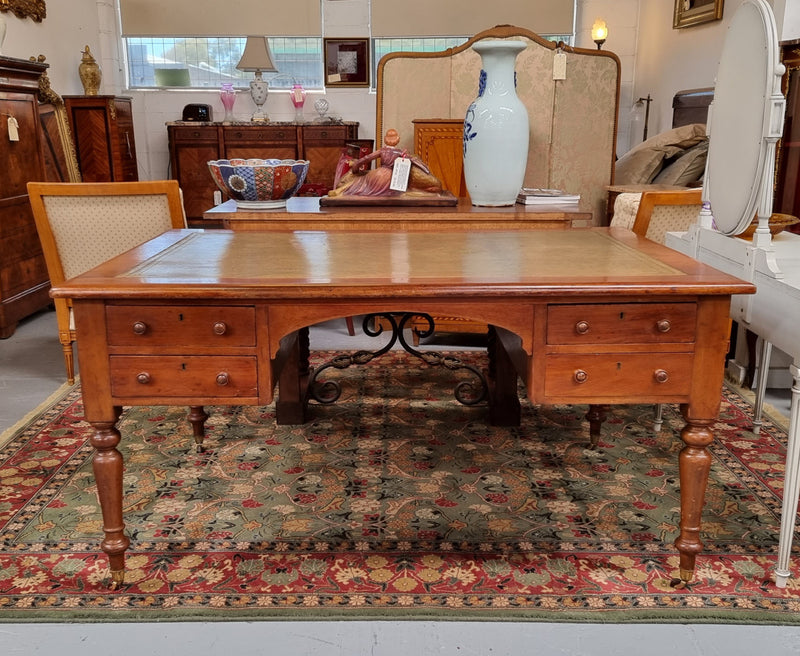 Australian Cedar full partners desk with attractive tooled leather top, four drawers either side and on caster wheels.  In good original detailed condition.